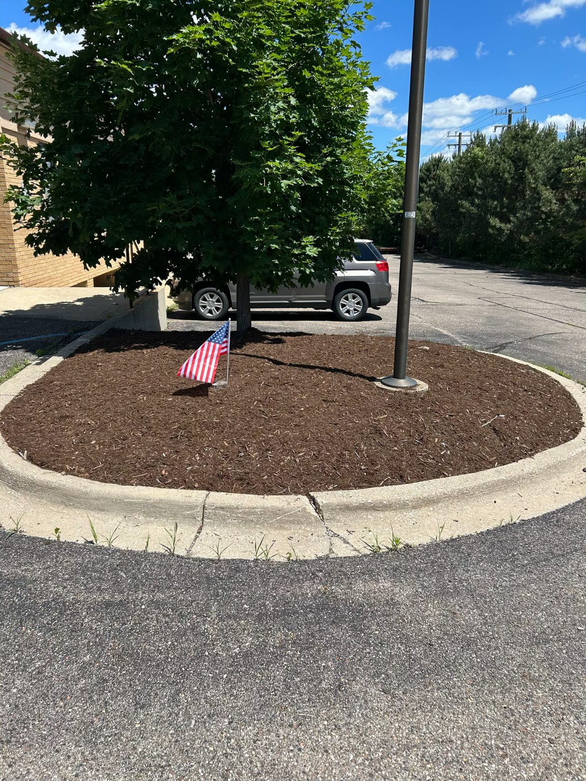 Fresh mulch installation on landscaping beds in Rochester, MI