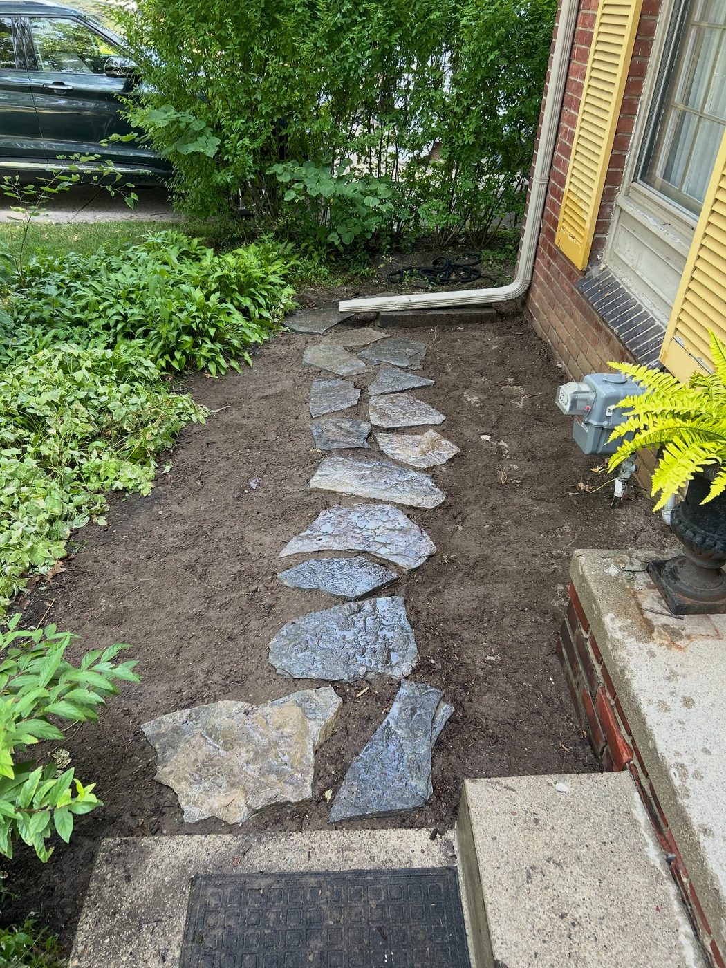 Natural flagstone walkway installed alongside a home in Rochester, MI